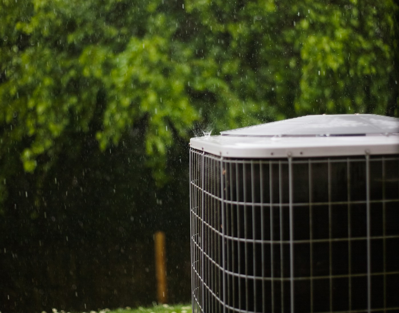 Outdoor air conditioning unit operating beside a home